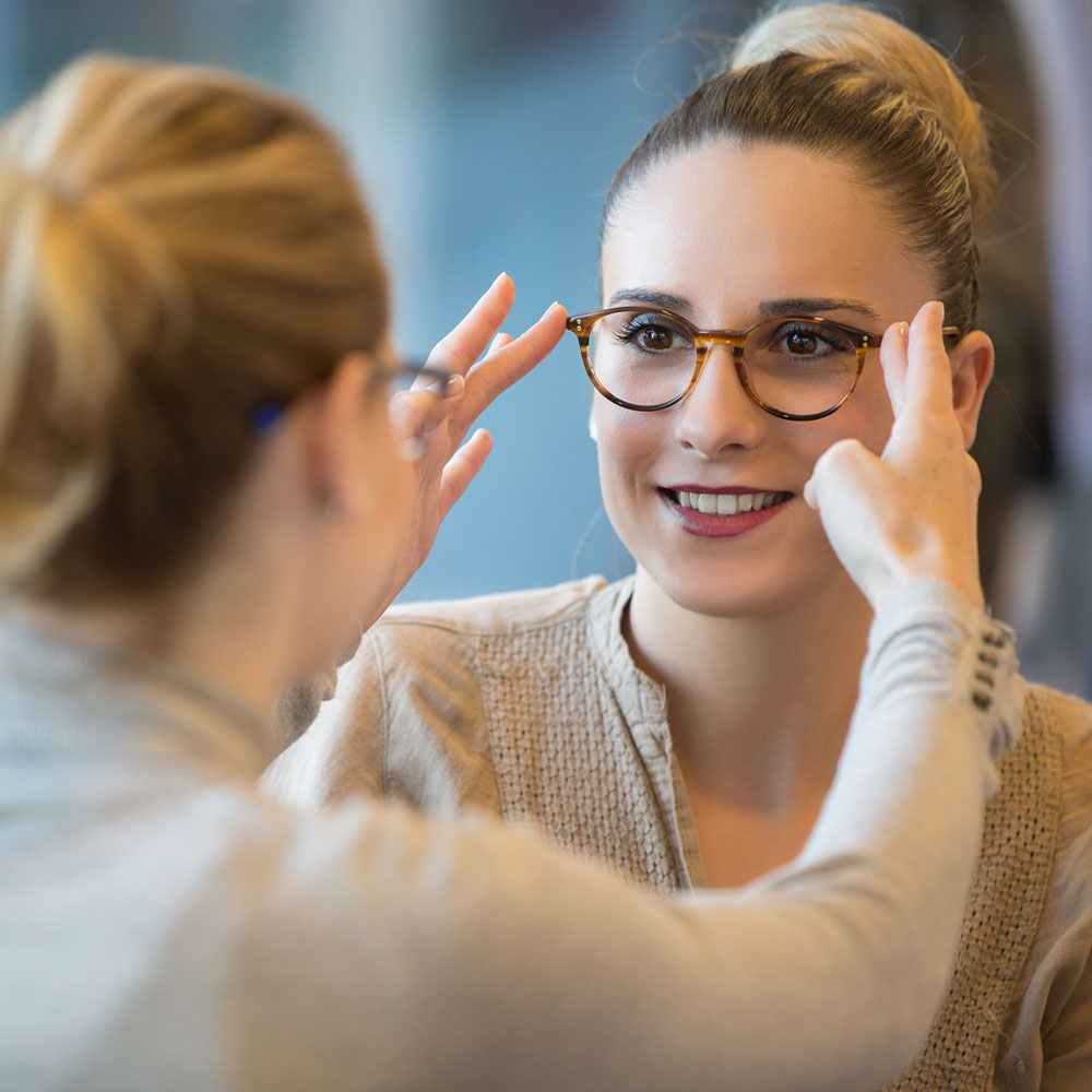 Woman having her glasses fitted in a practice Woman having her glasses fitted in a practice